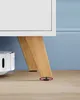 Close-up of furniture legs on a wooden floor with a blue background. Náhled obrázku produktu