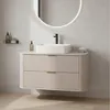 A modern bathroom vanity with a sink and faucet against a tiled wall. Anteprima dell’immagine prodotto