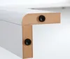 Close-up of two pieces of white-coated particleboard joined at a right angle, with black circular fasteners visible on each piece. Voir les images du produit