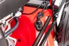 A close-up view of the internal components of a red lawnmower. Náhľad obrázku produktu