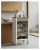 A kitchen cart with a stainless steel top, three wire baskets, a drawer, and a bottle holder, placed in a modern kitchen setting. Anteprima dell’immagine prodotto
