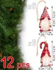 Christmas tree ornaments shaped like gnomes, displayed with pine branches and text indicating quantity and size. Náhled obrázku produktu