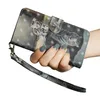 A hand holding a wallet-style phone case with a cat and tiger print. Produktbild-Vorschau