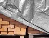 A stack of bricks covered by a silver tarp. Produktbild-Vorschau