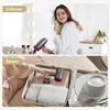 A split image showing a woman using a hairdryer at home and a hairdryer being packed into a suitcase for travel. Produktbild-Vorschau