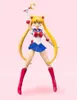 A Sailor Moon action figure posed against a plain pink background. Produktbild-Vorschau