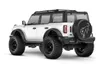 A white remote-controlled car resembling a Ford Bronco, shown from a rear-side angle on a white background. Produktbild-Vorschau