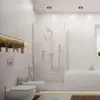 A modern, minimalist bathroom with a toilet, bidet, and bathtub. Produktbild-Vorschau