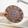 A hand is holding a decorative plate under running water in a sink. Náhled obrázku produktu