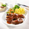 A plate of food with meat, noodles, and vegetables. Produktbild-Vorschau