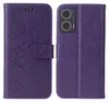 A purple flip phone case with a floral and butterfly embossed design is shown open, displaying the inside and outside of the case. Produktbild-Vorschau