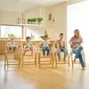 A woman and four children are sitting in high chairs in a modern kitchen. Voir les images du produit