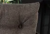 Close-up of a tufted fabric cushion with a button. Produktbild-Vorschau