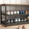 A shoe rack with multiple shelves filled with shoes, placed against a tiled wall. Náhled obrázku produktu