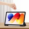 A hand is holding a stylus above a tablet in a black case, which is propped up on a wooden surface. Náhľad obrázku produktu