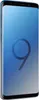 A blue Samsung Galaxy S9 Plus smartphone is shown from a slightly angled side view against a gradient blue and gray background. Voir les images du produit
