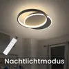 A modern LED ceiling light fixture with a remote control in a bedroom setting. Produktbild-Vorschau
