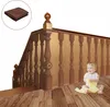 A baby playing on the floor next to a staircase railing protected by a mesh net. Náhľad obrázku produktu