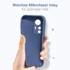 A hand holding a blue phone case against a white background. Produktbild-Vorschau