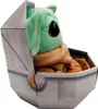A plush toy of Baby Yoda in its pram. Produktbild-Vorschau