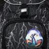Close-up of a backpack with a lightning bolt pattern and a patch with a robot graphic. Voir les images du produit