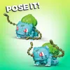 Two toy figures of the Pokemon Bulbasaur are shown in different poses against a gradient green and yellow background. Produktbild-Vorschau