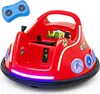 A red electric bumper car for children, shown from a slightly elevated front-diagonal angle, with a blue remote control hovering above and to the left. Produktbild-Vorschau
