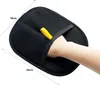 A hand is shown inside a black grooming glove, demonstrating its use. Produktbild-Vorschau