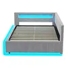 A light gray upholstered bed frame with a slatted mattress base and integrated blue LED lighting. Produktbild-Vorschau