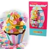 A cupcake decorated with colorful confetti and a box of confetti shredder. Produktbild-Vorschau