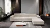 A modern living room with a large sectional sofa, coffee table, and fireplace. Náhľad obrázku produktu