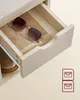Close-up of an open drawer with sunglasses inside, part of a shoe bench. Náhled obrázku produktu