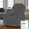 A gray recliner chair is shown in a living room setting with a sofa and windows in the background. Náhled obrázku produktu