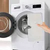 A hand is holding a white mop pad in front of an open washing machine. Produktbild-Vorschau