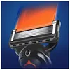 Close-up of a razor head with orange lubrication strip. Produktbild-Vorschau