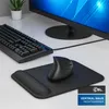 A black vertical mouse and keyboard are placed on a white desk next to a computer monitor. Produktbild-Vorschau