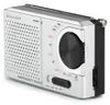 A silver and black portable emergency radio is shown from a slightly elevated angle against a white background. Voir les images du produit