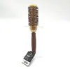 A round hair brush displayed on a clear stand against a white background. Náhled obrázku produktu