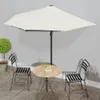 An outdoor patio scene with a table and chairs under a large umbrella. Náhľad obrázku produktu