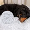 A dog sleeping on a plush dog bed. Náhled obrázku produktu