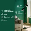 A floor lamp with two adjustable heads is shown next to a sofa in a room with green walls. Náhled obrázku produktu