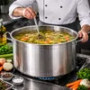 A chef stirring a large pot of soup on a stovetop. Produktbild-Vorschau