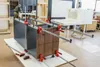 A workshop setting where a cabinet or furniture piece is being assembled using clamps. Produktbild-Vorschau