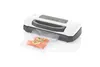 A white and gray vacuum sealer machine with a bag of salmon in front of it. Náhľad obrázku produktu