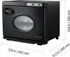 A black towel warmer with a clear window on the front, showing rolled towels inside. Dimensions are indicated with lines and text. Produktbild-Vorschau