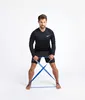 A man is performing a resistance band exercise. Podgląd zdjęcia produktu