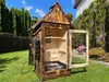 A wooden smoker in a backyard setting. Náhled obrázku produktu
