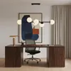 A modern office desk setup with a chandelier, desk lamp, chair, and abstract art. Produktbild-Vorschau