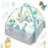 A dinosaur-themed playmat with arches and hanging toys. Anteprima dell’immagine prodotto