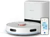 A white robot vacuum cleaner and its charging base are shown next to a smartphone displaying the vacuum's app. Produktbild-Vorschau